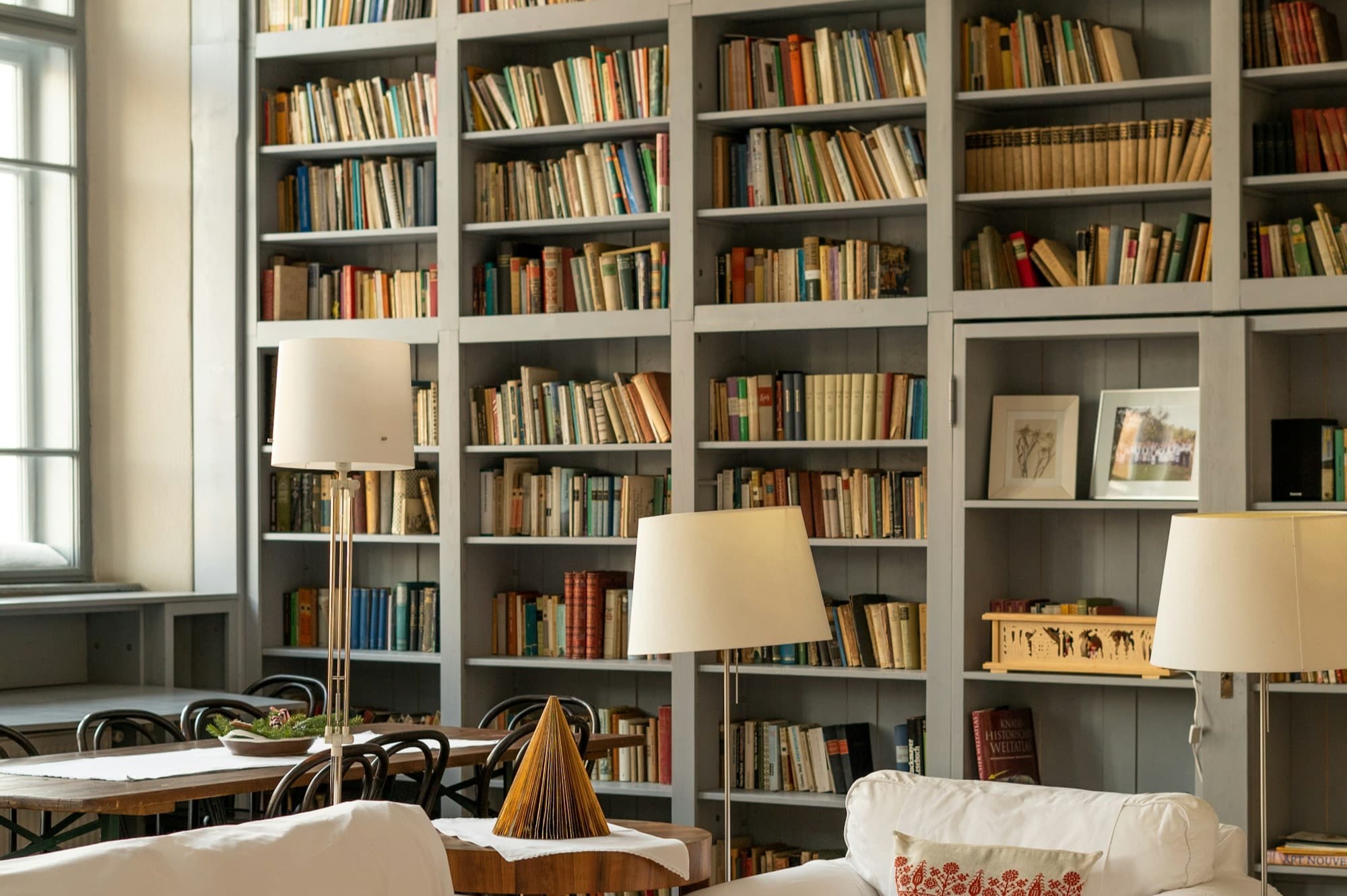 Floor-to-ceiling home library with reading chairs